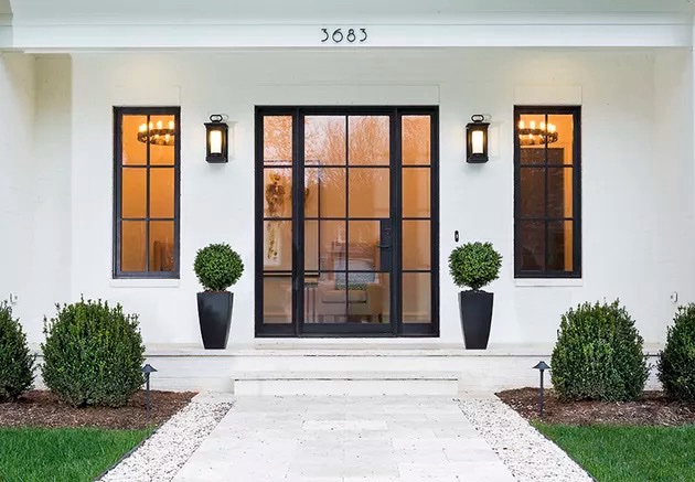 Black custom SlimLine steel entry doors and sidelights on a luxury residence